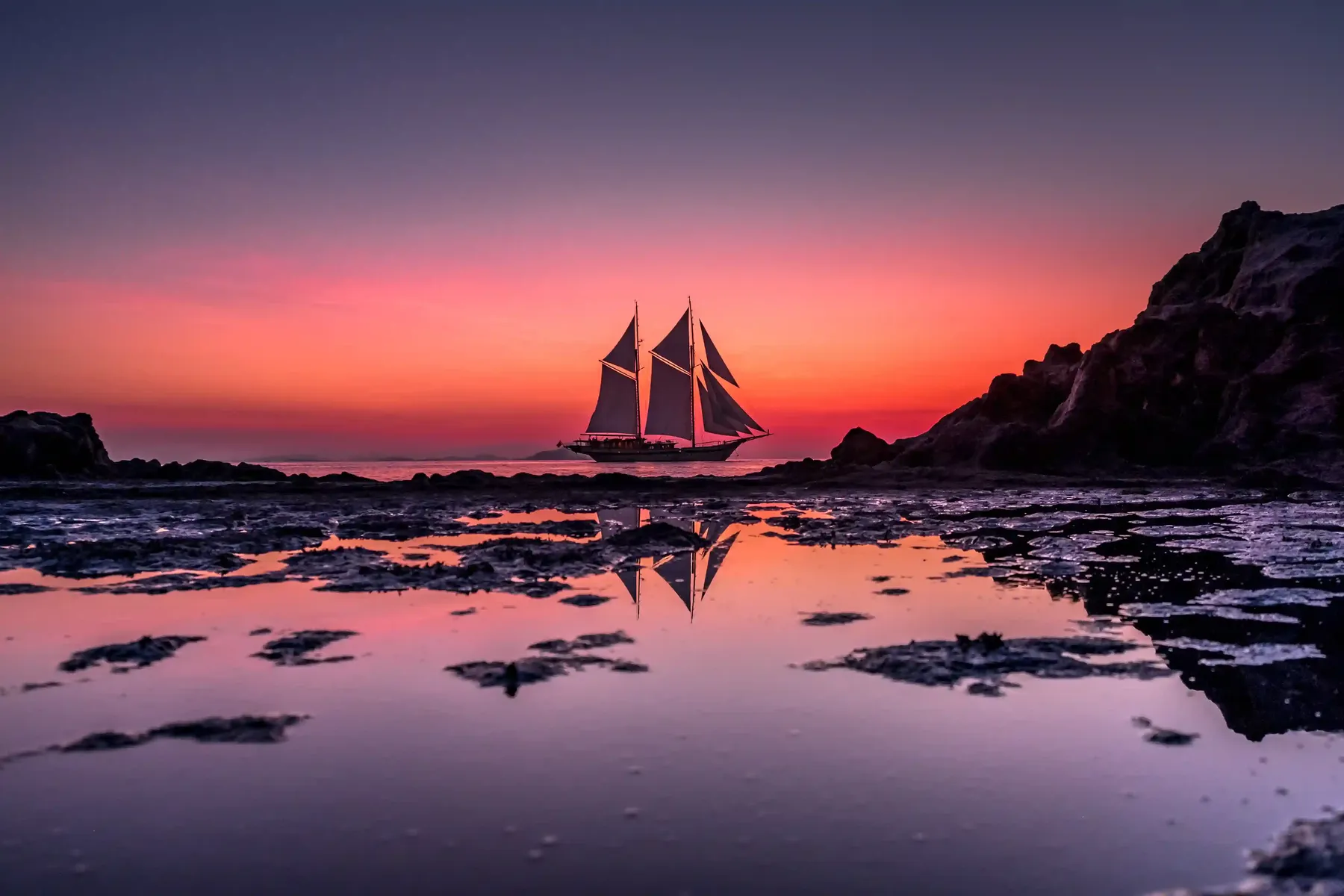 Phinisi under sail at sunset in the Flores Sea