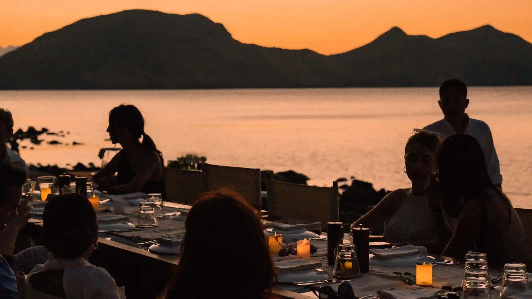 Dinner served on deck as the sun sets over Komodo